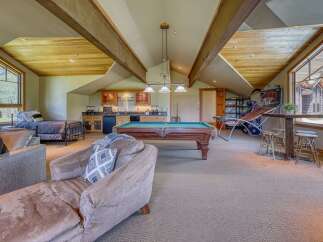 This spacious recreational room offers a perfect blend of relaxation and entertainment, featuring a full-size pool table and a well-equipped wet bar.