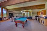 This spacious recreation room offers a perfect blend of entertainment and relaxation, featuring a full-size pool table as the centerpiece.