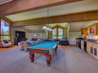 This spacious recreation room offers a perfect blend of entertainment and relaxation, featuring a full-size pool table as the centerpiece.