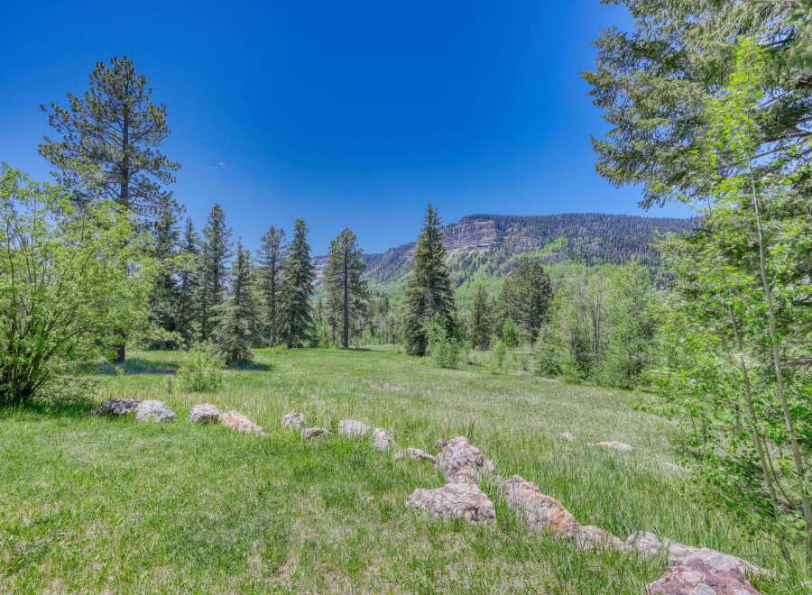 Discover this stunning property nestled amidst a serene landscape, offering breathtaking mountain views and lush green meadows.