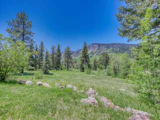 Discover this stunning property nestled amidst a serene landscape, offering breathtaking mountain views and lush green meadows.