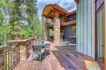 Enjoy outdoor living on this expansive wooden deck, perfect for entertaining or relaxing amidst lush greenery.