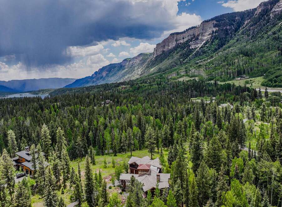 Nestled amidst a lush forest and towering mountains, this stunning property offers a serene escape with breathtaking natural beauty.
