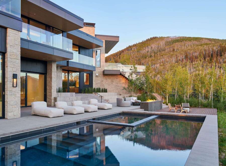 Experience luxury living with this stunning modern home featuring a sleek infinity pool and expansive outdoor entertaining space.