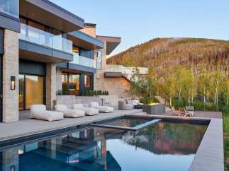 Experience luxury living with this stunning modern home featuring a sleek infinity pool and expansive outdoor entertaining space.