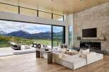 Experience luxurious mountain living in this stunning contemporary home, featuring expansive glass walls that seamlessly blend indoor and outdoor spaces with breathtaking panoramic views.