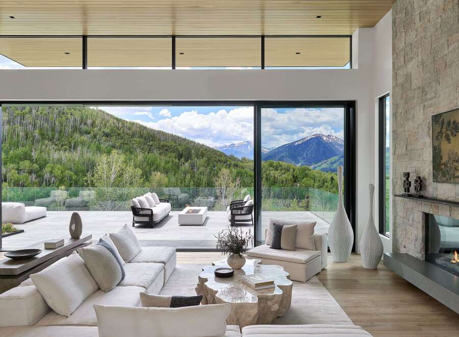 Experience luxurious mountain living in this stunning home, featuring expansive glass walls that seamlessly blend indoor and outdoor spaces.
