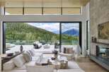 Experience luxurious mountain living in this stunning home, featuring expansive glass walls that seamlessly blend indoor and outdoor spaces.