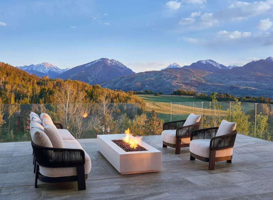 Experience luxury living with this stunning mountain view estate, featuring a modern outdoor lounge area perfect for entertaining.