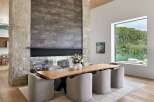 Experience modern luxury in this stunning dining area, featuring a live-edge wood table and plush upholstered chairs.