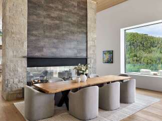 Experience modern luxury in this stunning dining area, featuring a live-edge wood table and plush upholstered chairs.