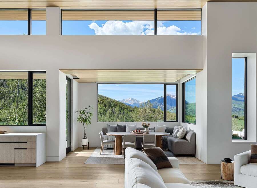 Experience breathtaking mountain views from this stunning modern living space, featuring expansive windows that flood the interior with natural light.