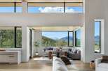 Experience breathtaking mountain views from this stunning modern living space, featuring expansive windows that flood the interior with natural light.