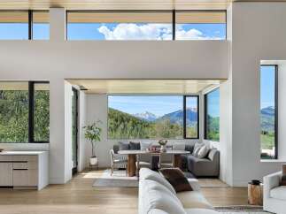 Experience breathtaking mountain views from this stunning modern living space, featuring expansive windows that flood the interior with natural light.