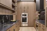 Experience modern luxury in this sleek kitchen, featuring custom wood cabinetry and integrated LED lighting for a sophisticated ambiance.