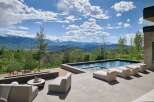 Experience luxury outdoor living with this stunning property featuring a modern infinity pool and a sleek fire pit area, perfect for entertaining.