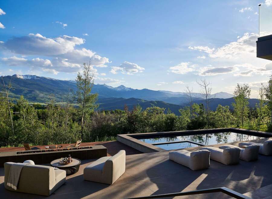 Experience luxury outdoor living with this stunning property featuring a modern infinity pool and a sleek fire pit area, perfect for entertaining.