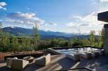 Experience luxury outdoor living with this stunning property featuring a modern infinity pool and a sleek fire pit area, perfect for entertaining.