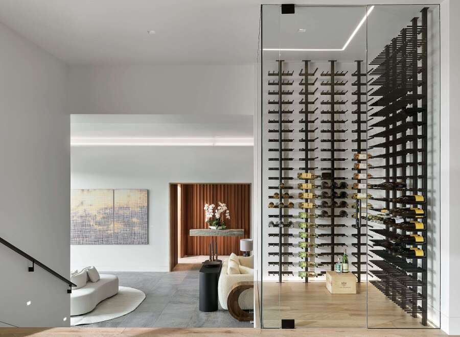 Experience luxury living with this stunning modern home featuring a state-of-the-art glass-enclosed wine cellar, perfect for the discerning collector.