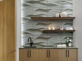 Experience tranquility in this spa treatment room, featuring a modern vanity with a sleek black faucet and ample storage.