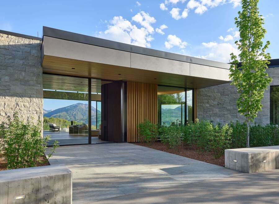 Experience modern luxury in this stunning home featuring expansive glass walls that seamlessly blend indoor and outdoor living.