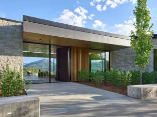 Experience modern luxury in this stunning home featuring expansive glass walls that seamlessly blend indoor and outdoor living.