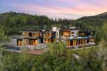 Experience luxury mountain living in this stunning modern estate, nestled amidst a serene forest landscape.