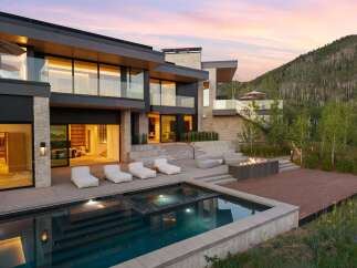 Experience luxury mountain living in this stunning modern estate, featuring a sleek infinity pool and spa overlooking a serene landscape.