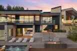 Experience luxury living in this modern architectural masterpiece, featuring expansive glass windows and sleek lines.