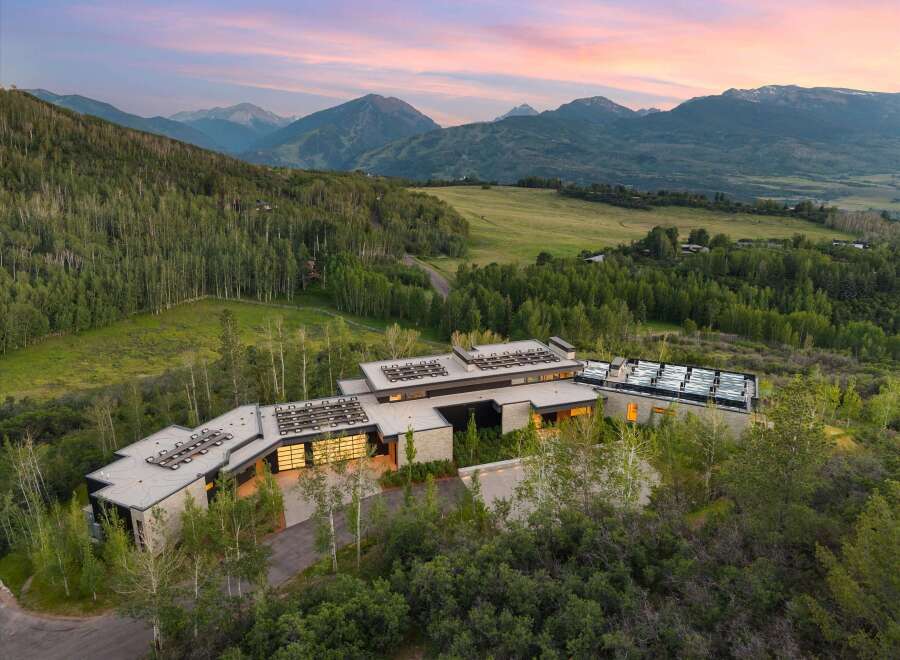 Experience luxury mountain living in this stunning contemporary estate, nestled amidst a serene forest with breathtaking panoramic views.