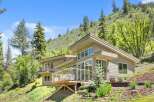 Nestled amidst a lush hillside, this contemporary home offers stunning natural views and a seamless indoor-outdoor living experience.