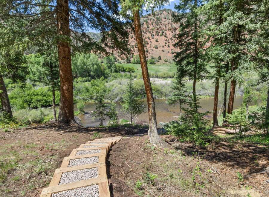 Discover this stunning property with a scenic pathway leading to a tranquil river.