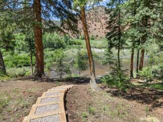 Discover this stunning property with a scenic pathway leading to a tranquil river.