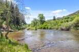 Experience serene living with this stunning property featuring a crystal-clear river flowing through lush greenery.