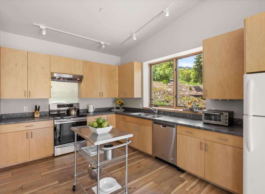 This modern kitchen features light wood cabinetry and sleek countertops, creating a bright and airy atmosphere.