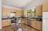 This modern kitchen features light wood cabinetry and sleek countertops, creating a bright and airy atmosphere.