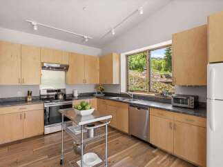 This modern kitchen features light wood cabinetry and sleek countertops, creating a bright and airy atmosphere.