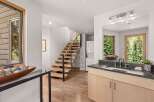 Experience modern living with this stunning home featuring a floating staircase and a sleek vanity area.