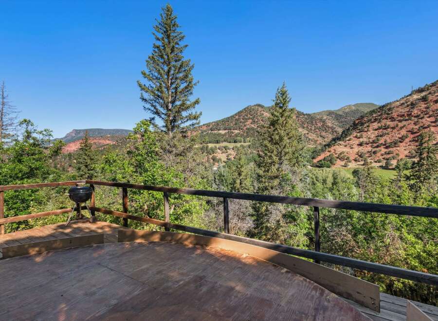 Enjoy breathtaking mountain views from this expansive wooden deck, perfect for outdoor entertaining or quiet relaxation.
