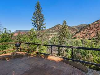 Enjoy breathtaking mountain views from this expansive wooden deck, perfect for outdoor entertaining or quiet relaxation.
