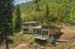 Nestled amidst lush greenery, this modern home offers a serene retreat with stunning natural views.
