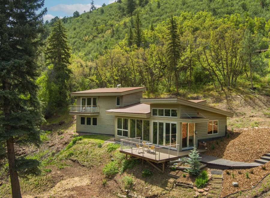 Nestled amidst lush greenery, this modern home offers a serene retreat with stunning natural views.