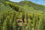 Nestled amidst a lush forest, this secluded home offers a tranquil retreat with stunning mountain views.