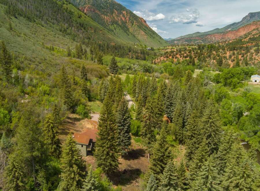 Nestled amidst a lush forest and rolling hills, this property offers a secluded retreat with stunning natural beauty.