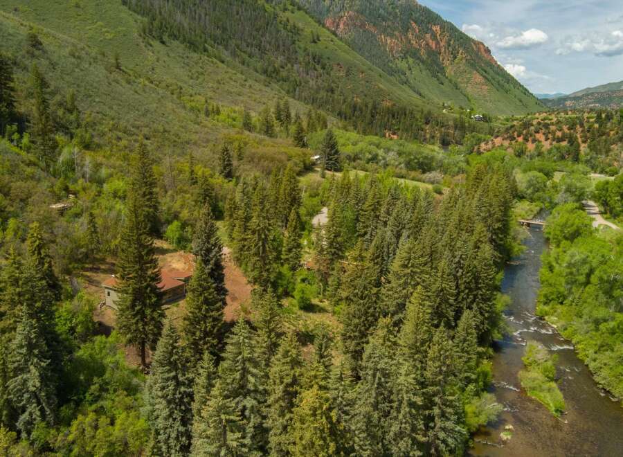 Nestled amidst a lush forest, this property offers a serene retreat with a charming cabin and a picturesque river flowing nearby.