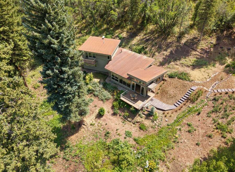 Nestled amidst lush greenery, this unique home offers a serene retreat with its distinctive architecture and natural surroundings.