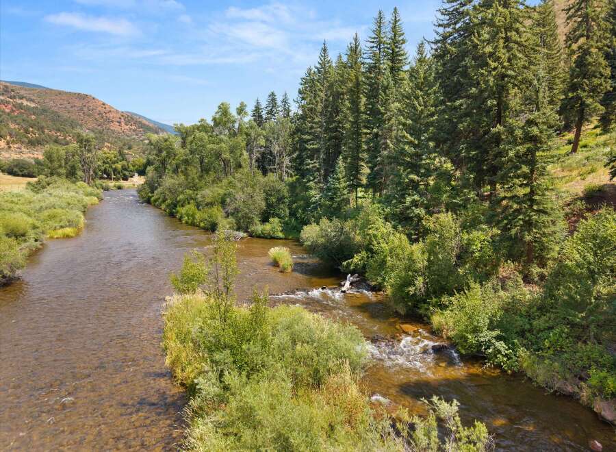 Experience the tranquility of this stunning riverside property, offering direct access to a pristine flowing river perfect for fishing or kayaking.