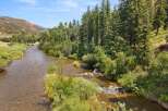 Experience the tranquility of this stunning riverside property, offering direct access to a pristine flowing river perfect for fishing or kayaking.