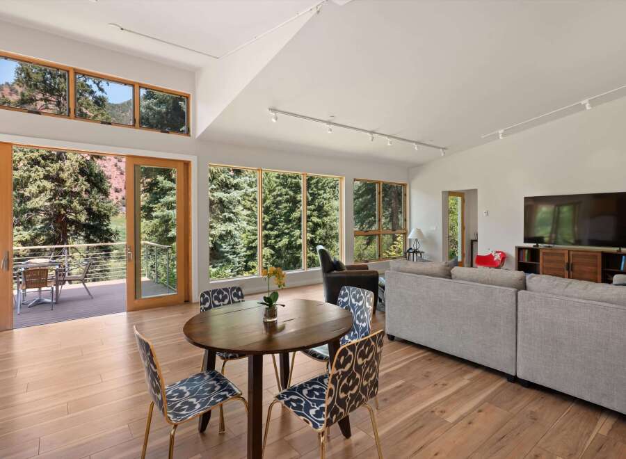 Experience breathtaking mountain views from this stunning living space, featuring expansive windows and a seamless indoor-outdoor flow.