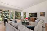 Experience modern living in this spacious great room, featuring a large sectional sofa and a stylish media console.
